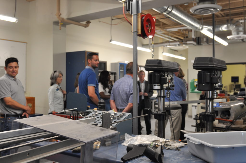 A group of adults receive a tour of a lab at Gonzaga University.