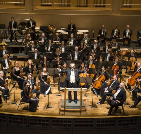 An overhead shot of an orchestra performing on stage.