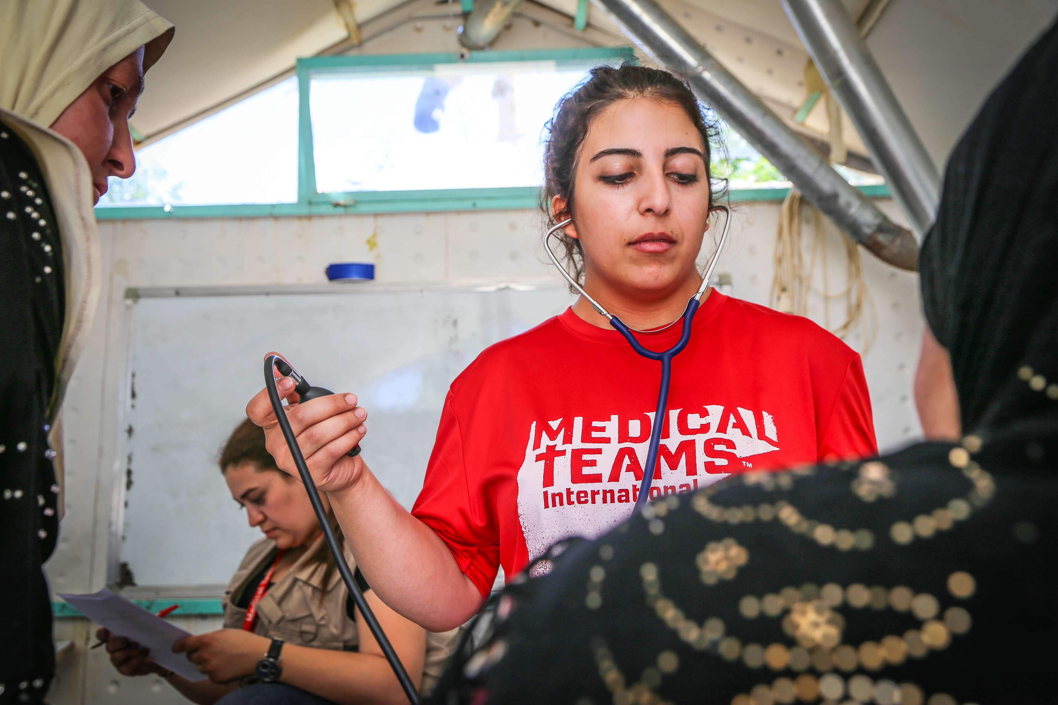 A volunteer administers medical care