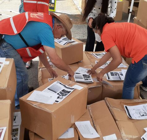 A group of volunteers sort boxes.