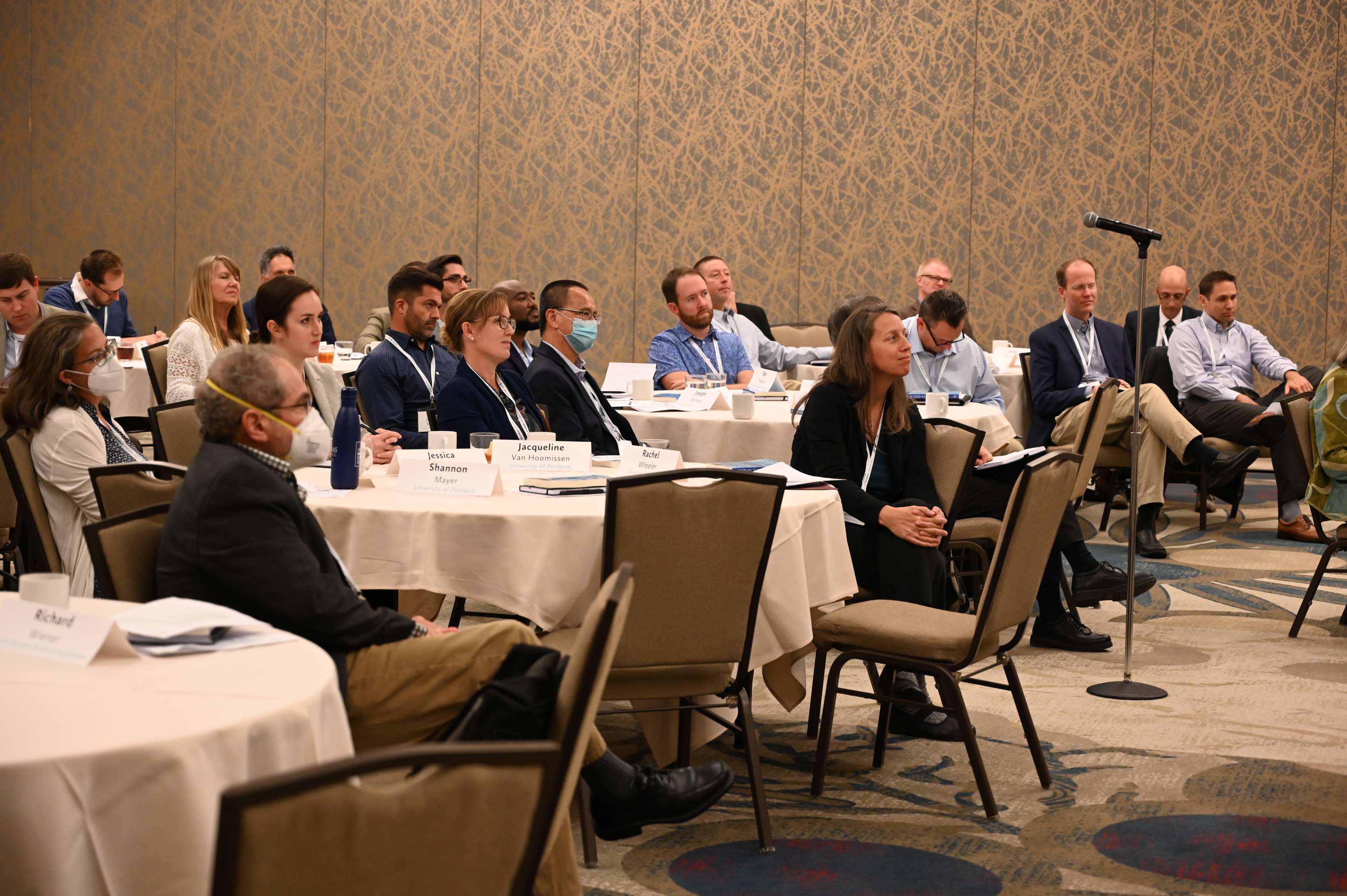 A group of participants at the Scientific Research and Christian Faith convening listen to a speaker.