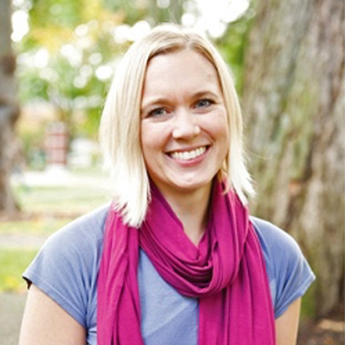 A 2022 Swanson Award winner, Dr. Cara Wall-Scheffler, a woman with short blond hair wearing a pink scarf and blue shirt.