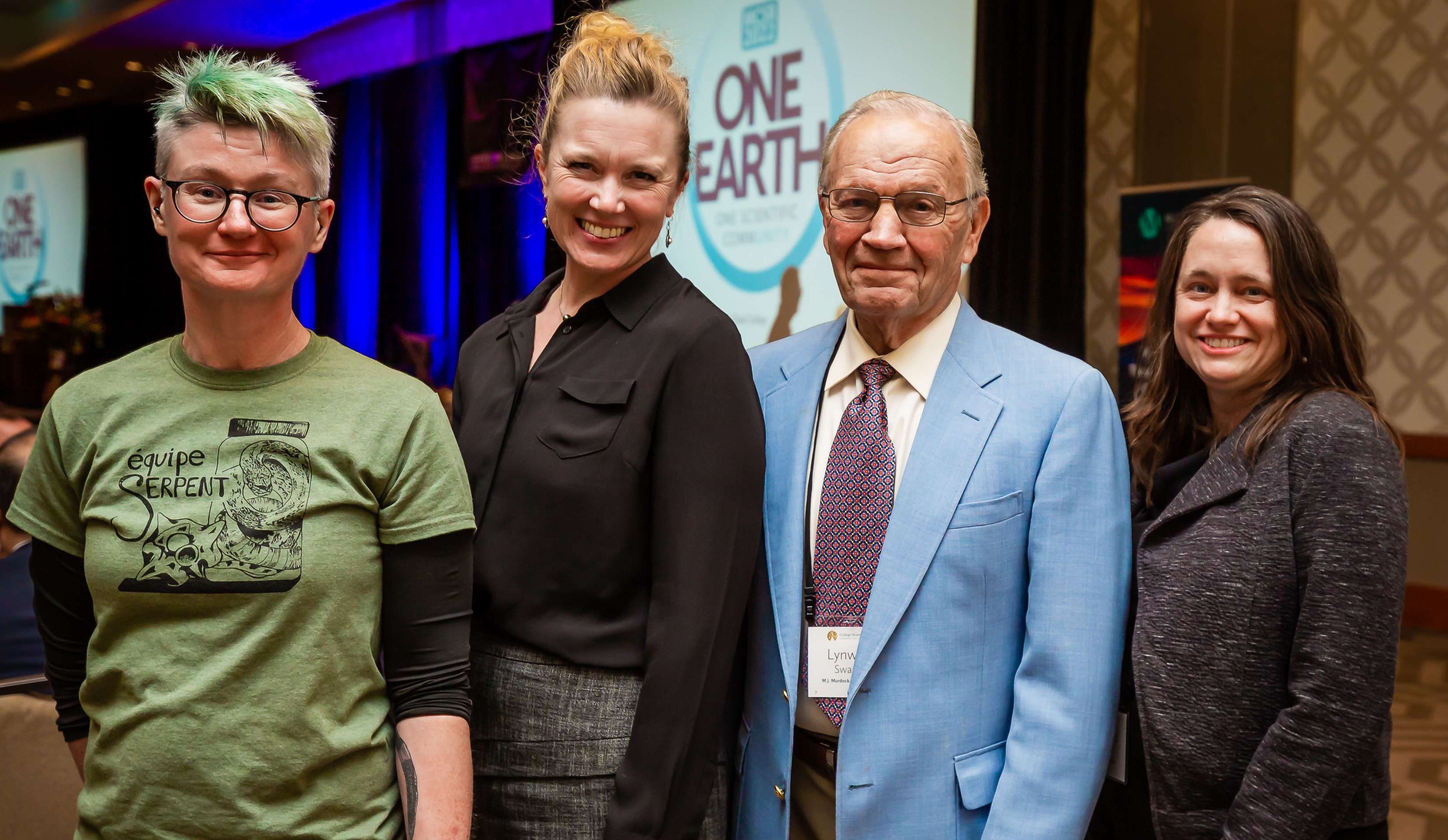 The three 2022 Swanson Award winners with Dr. Lynwood Swanson; from left to right, Dr. Kate Jackson in a green t-shirt, Dr. Cara Wall-Scheffler in a black blouse, Dr. Lynwood Swanson in a blue suit, and Dr. Margaret Metz in a dark gray blazer.