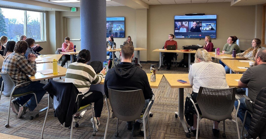 Jesse Tree of Idaho staff meeting, with staff sitting in desks in a circle